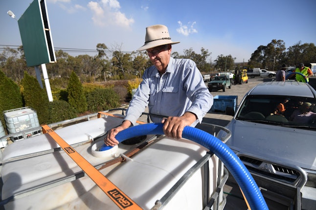 A man collects the water handed out by a local charity group in Stanthorpe, Queensland, Australia, 16 October 2019 (issued 29 October 2019). The town of Stanthorpe has been struggling with severe drought and consequential bushfires since September 2019. With the dam's water level down to 25 percent, the town faces an imminent water shortage. Queensland Premier Annastacia Palaszczuk announced in September 2019 a plan to truck in 1.6 million liters of water from a nearby dam to the Storm King Dam, as Stanthorpe is predicted to run out of water by Christmas.