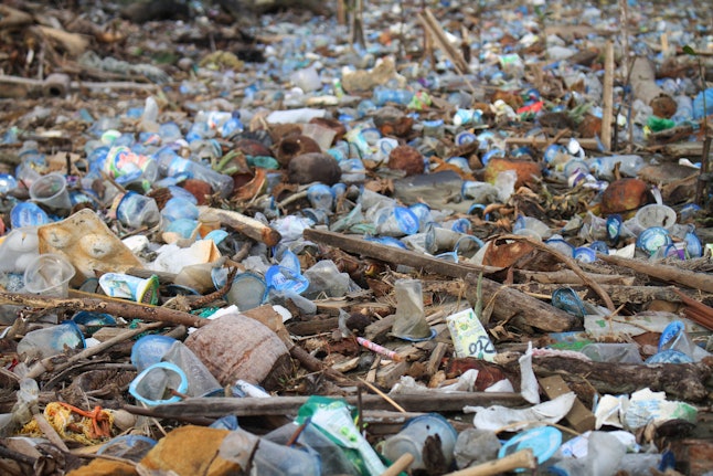 Piles of plastic waste cover the river as it flows into the sea